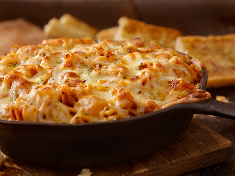 Cheesy Baked Rotini Pasta In Roasted Tomato And Garlic Sauce With Garlic Bread