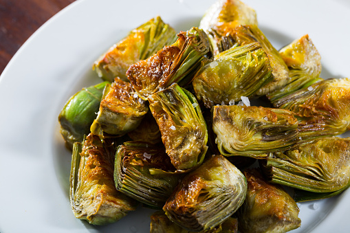 Delicious Oil Fried Cut Artichokes Served On Plate. Healthy Food